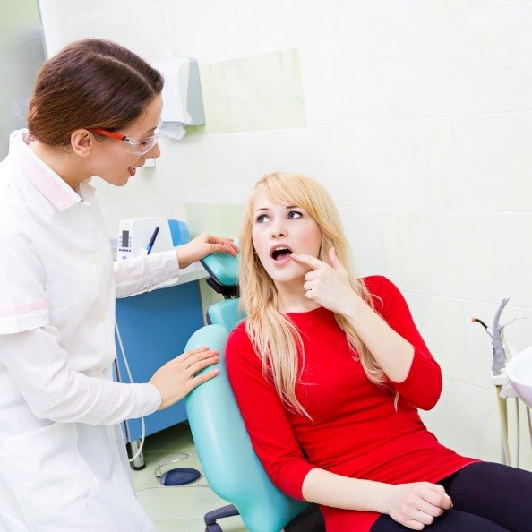 Woman pointing to smile before wisdom tooth extraction