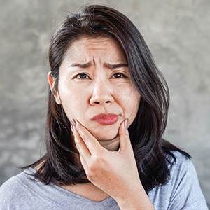 Dentures patient in Fort Worth holding their jaw